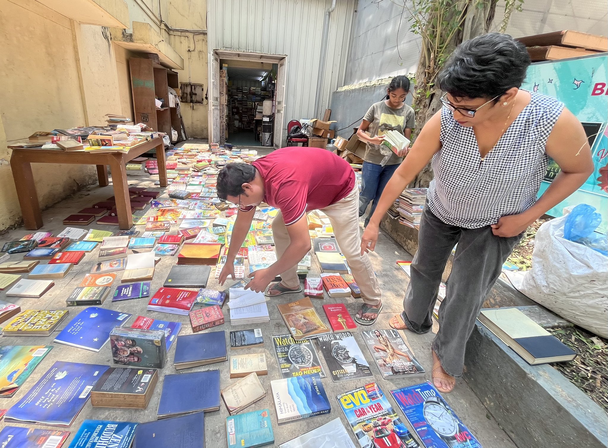 Damaged books from Bookworm laid out to dry in the sun outside the bookstore