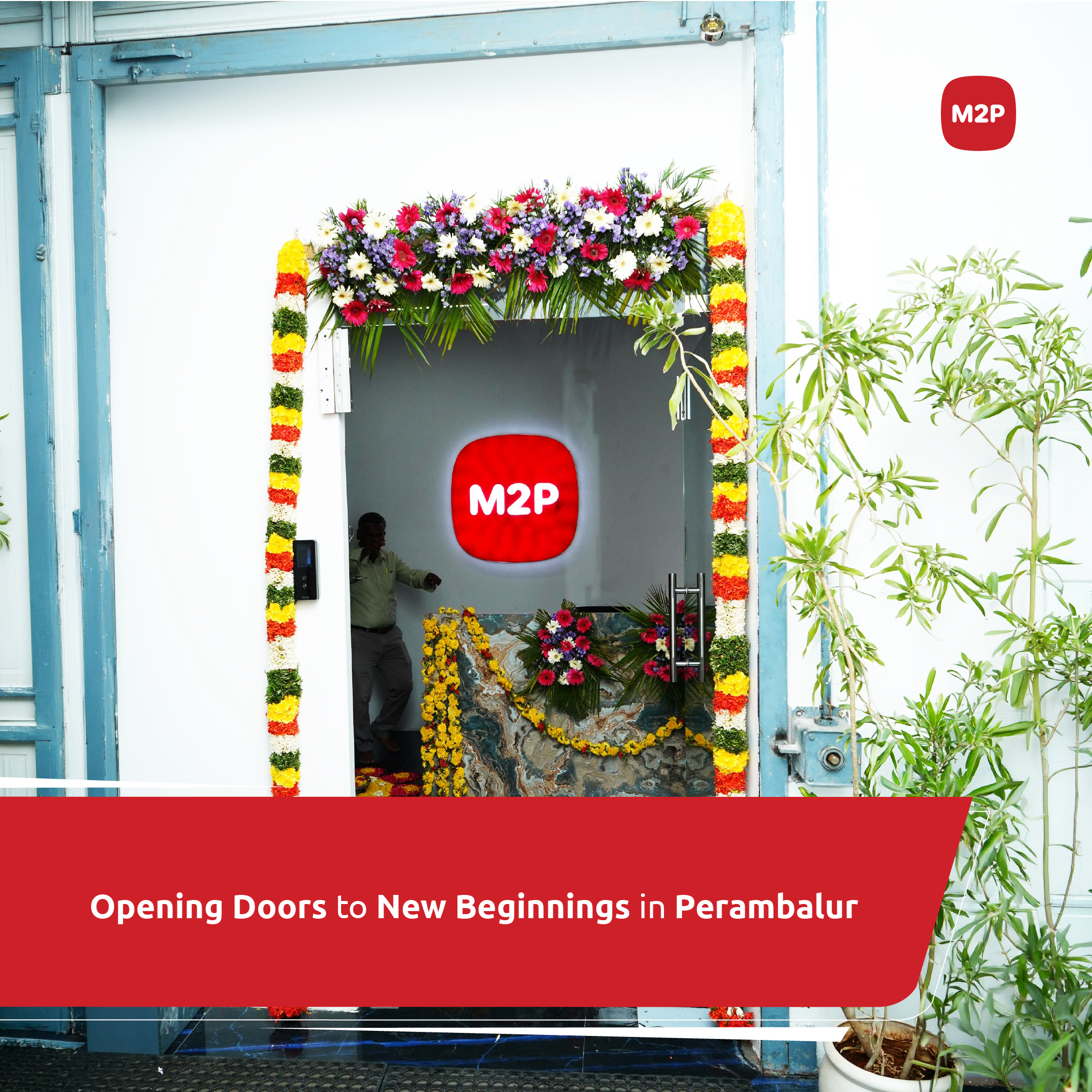 M2P Fintech's Perambalur office entrance, decorated with garlands; the door reads 'Opening Doors to New Beginnings in Perambalur'