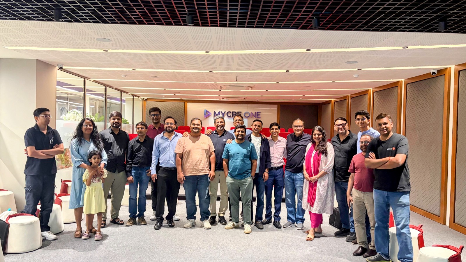 Group photo at the eChai AI Social at MYCPE ONE HQ: founders of eChai Partner Brands standing together in the venue under the MYCPE ONE signage on the back wall
